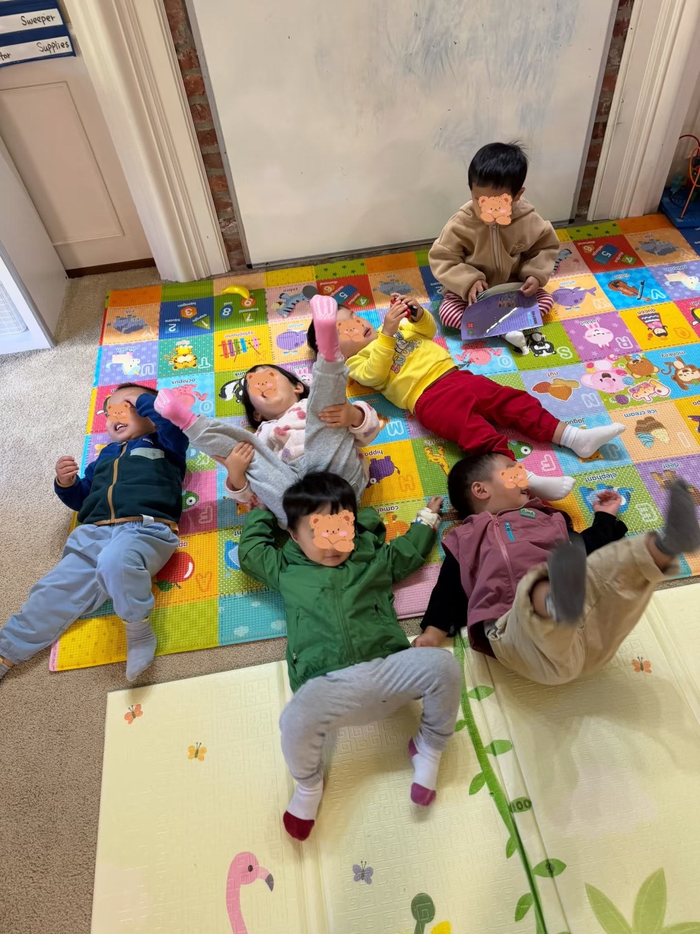 Panda Bear Childcare — toddlers playing on colorful foam mat