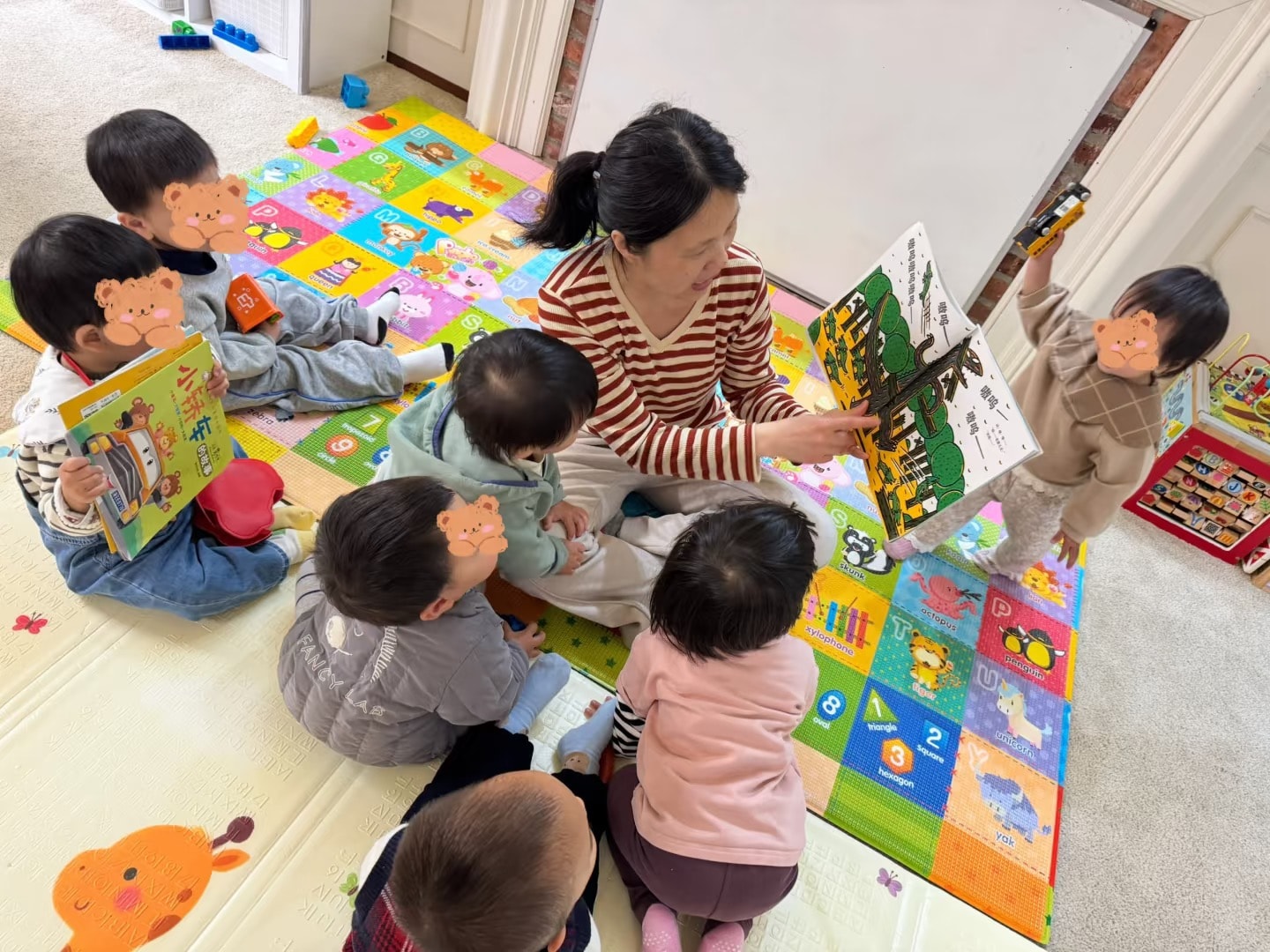 Panda Bear Childcare — teacher reading picture books with toddlers