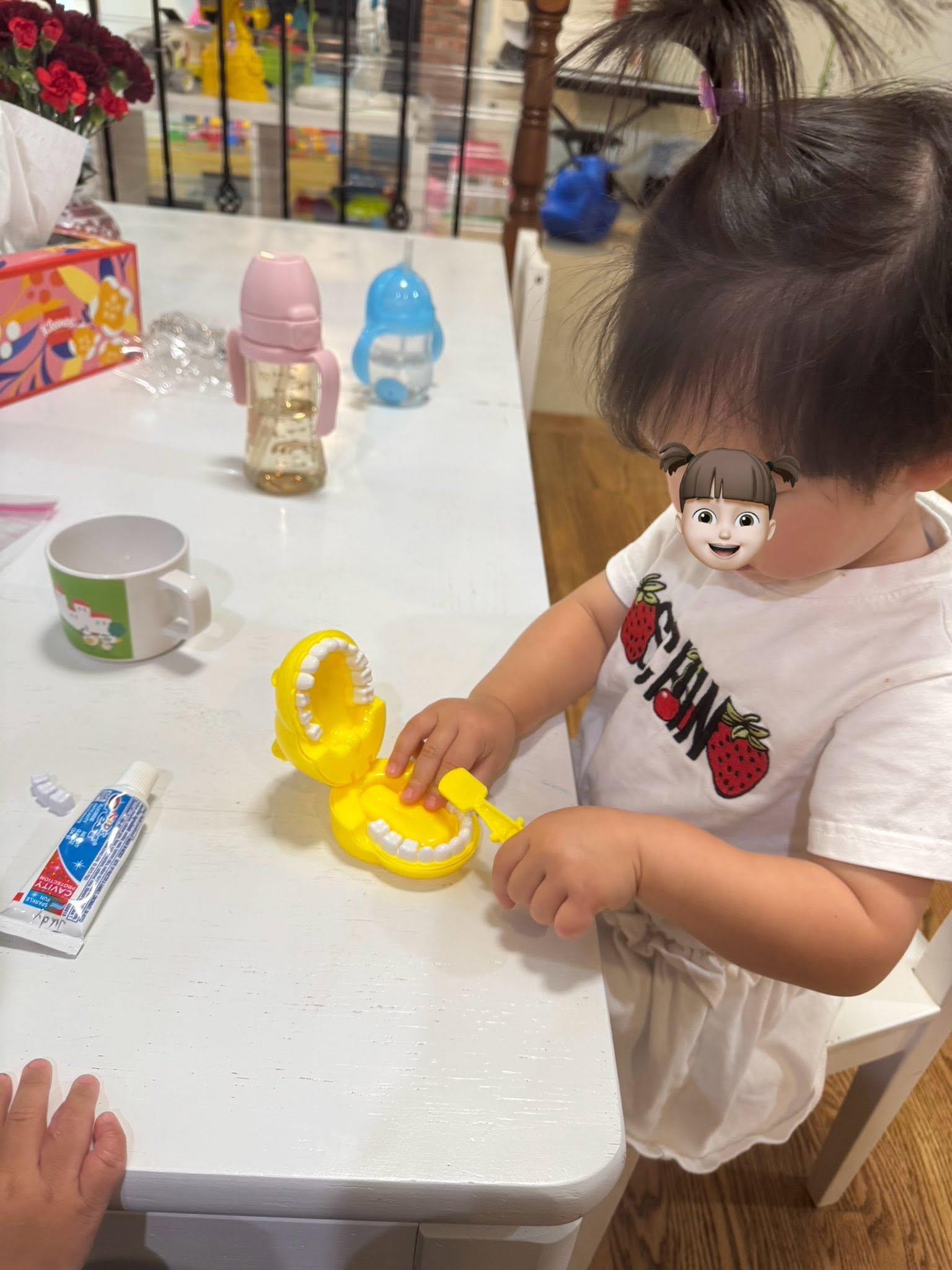 Panda Bear Childcare — child playing with yellow toy dinosaur