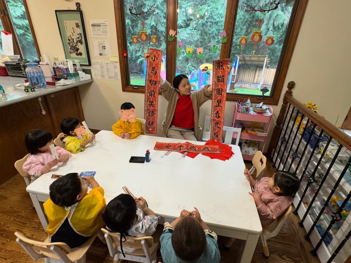 Panda Bear Childcare — children learning chinese calligraphy with teacher