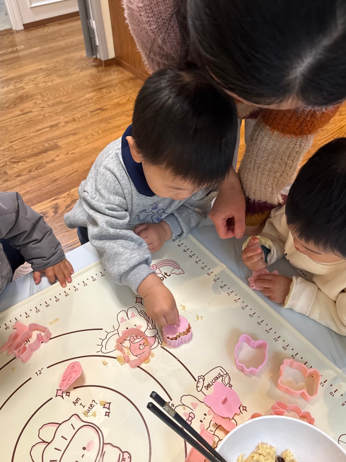 Panda Bear Childcare — toddler playing with pink cookie cutters activity